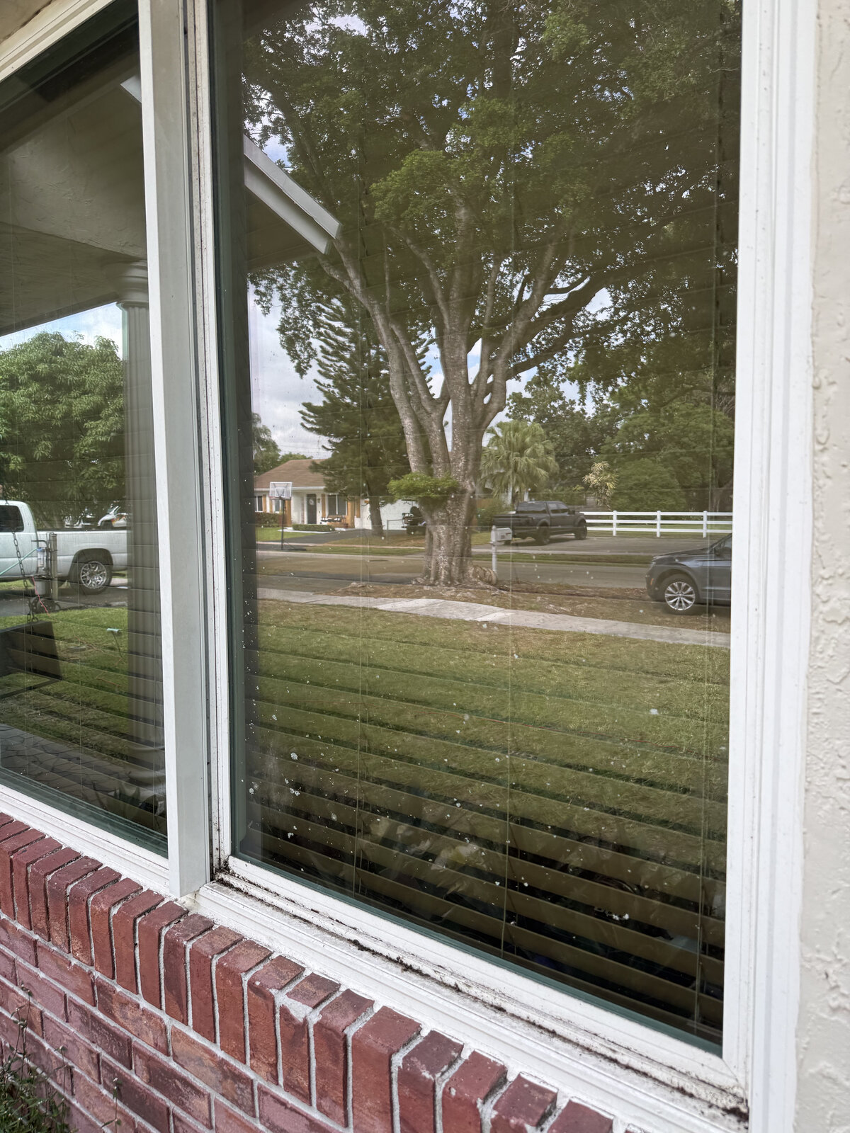 Dirty front window with water spots and grime